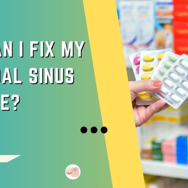 An informative slide from Dr. Rajarshi Mitra, Specialist Laparoscopic Surgeon & Proctologist in Abu Dhabi, presenting self-care options for pilonidal sinus. The image displays a person's hand holding a blister pack of colorful medications with a pharmacy shelf in the background, symbolizing home treatment possibilities. The slide asks, 'How Can I Fix My Pilonidal Sinus at Home?' highlighting the self-management aspect of the condition against a dual teal and yellow backdrop, along with the clinic's logo.